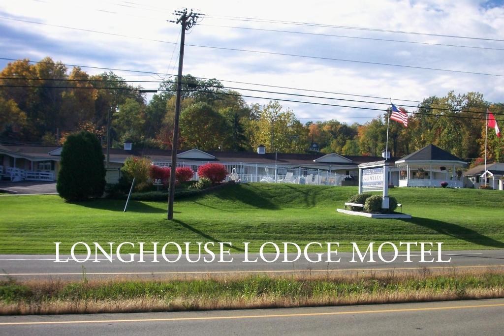 a sign for a longhouse lodge motel on a street at Longhouse Lodge Motel in Watkins Glen