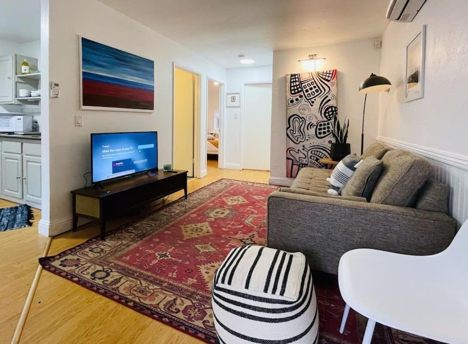 a living room with a couch and a television at Artist's retreat near the heart of the city in Sacramento