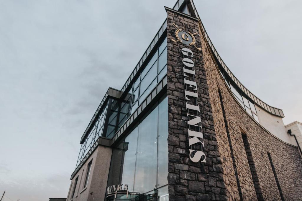 a building with a clock on the side of it at Golflinks Hotel in Portrush