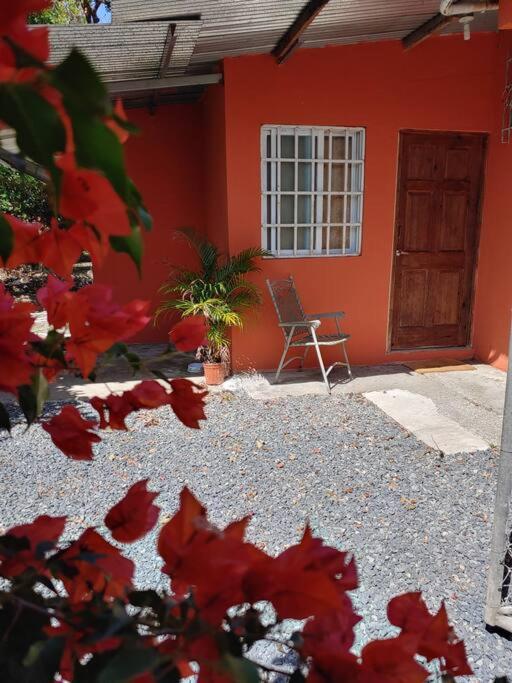 una casa roja con una silla delante en Cozy 1 br 1 bath apartment with free parking, en Penonomé