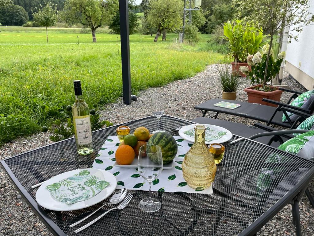 a table with a plate of fruit and a bottle of wine at Apartment Joel by Interhome in Stockach