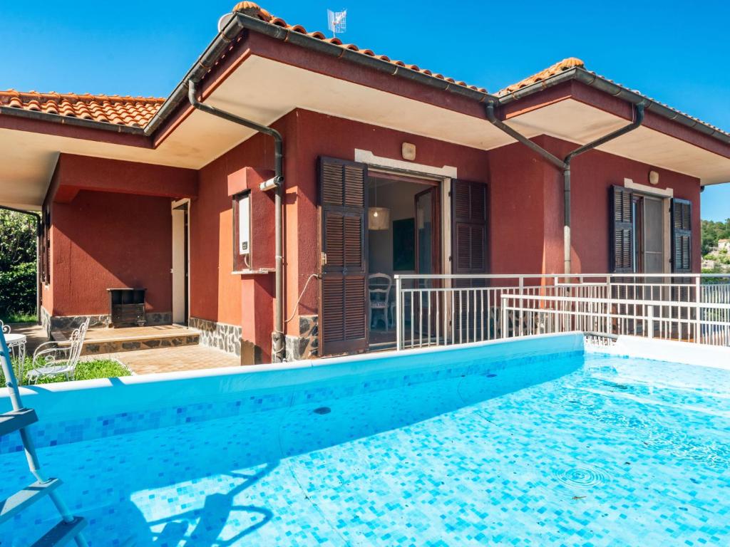 a house with a swimming pool in front of it at Apartment Villa Michelle by Interhome in Bardino Nuovo