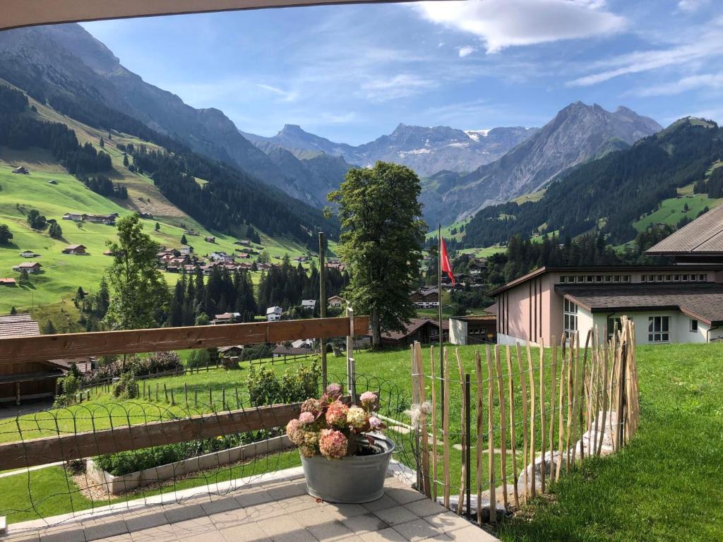 a garden with a view of a valley with mountains at Apartment Lohnerblick by Interhome in Adelboden
