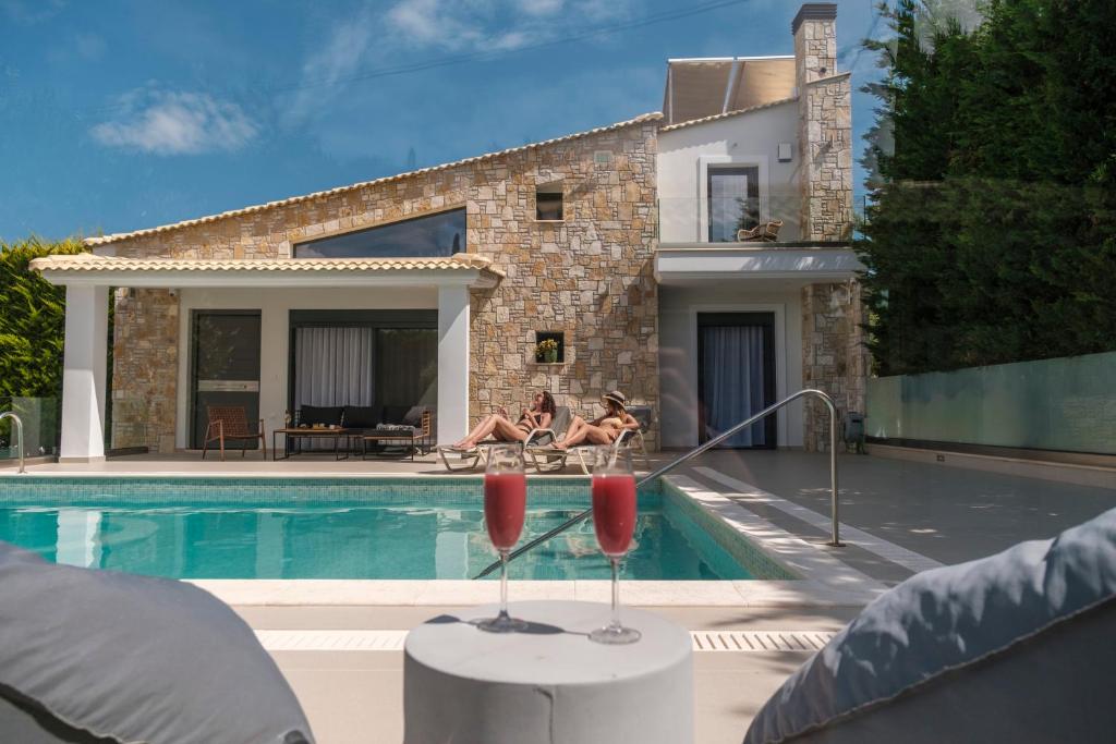 a house with a swimming pool with two people in the background at Shemesh Residence in Nafplio
