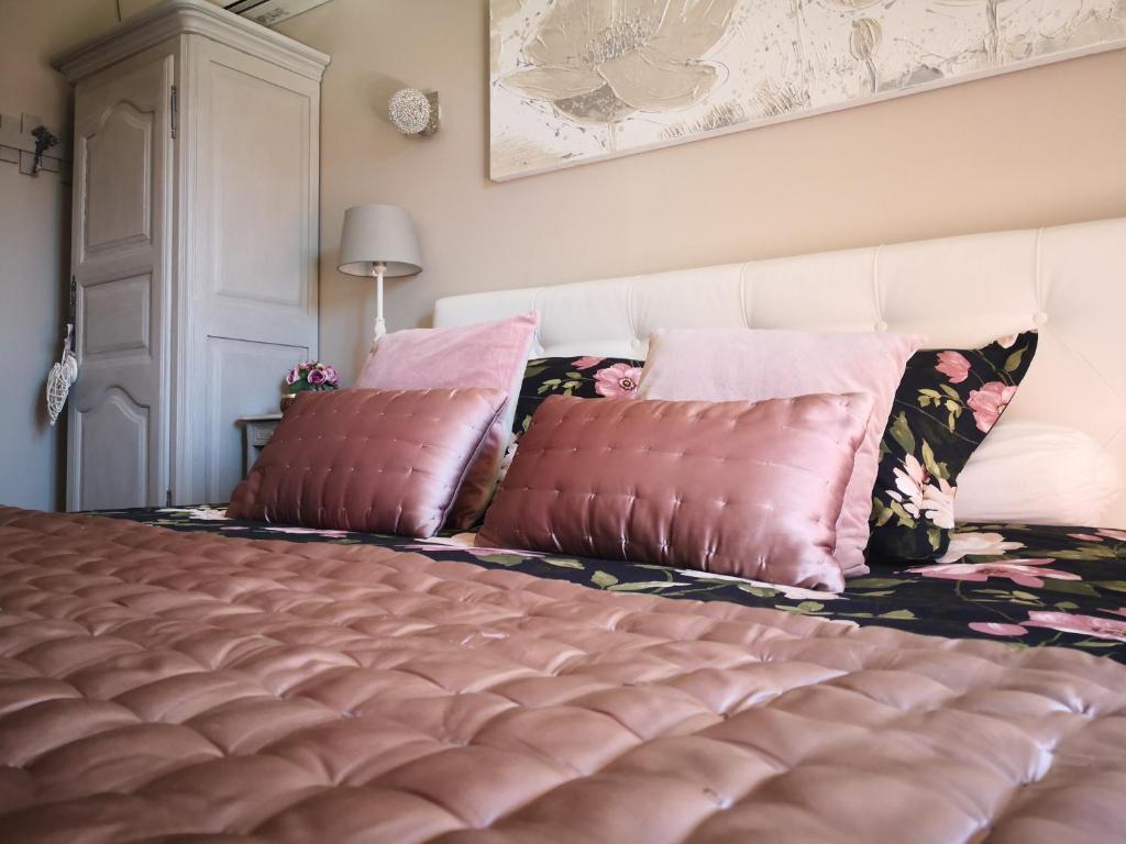 een slaapkamer met een bed met 2 kussens erop bij La Chabertine in Garéoult