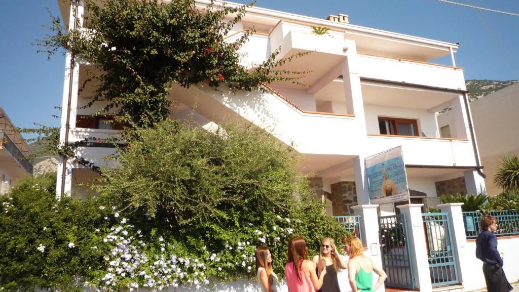 a group of girls walking in front of a building at Biriola EcoResort Cala Gonone in Cala Gonone
