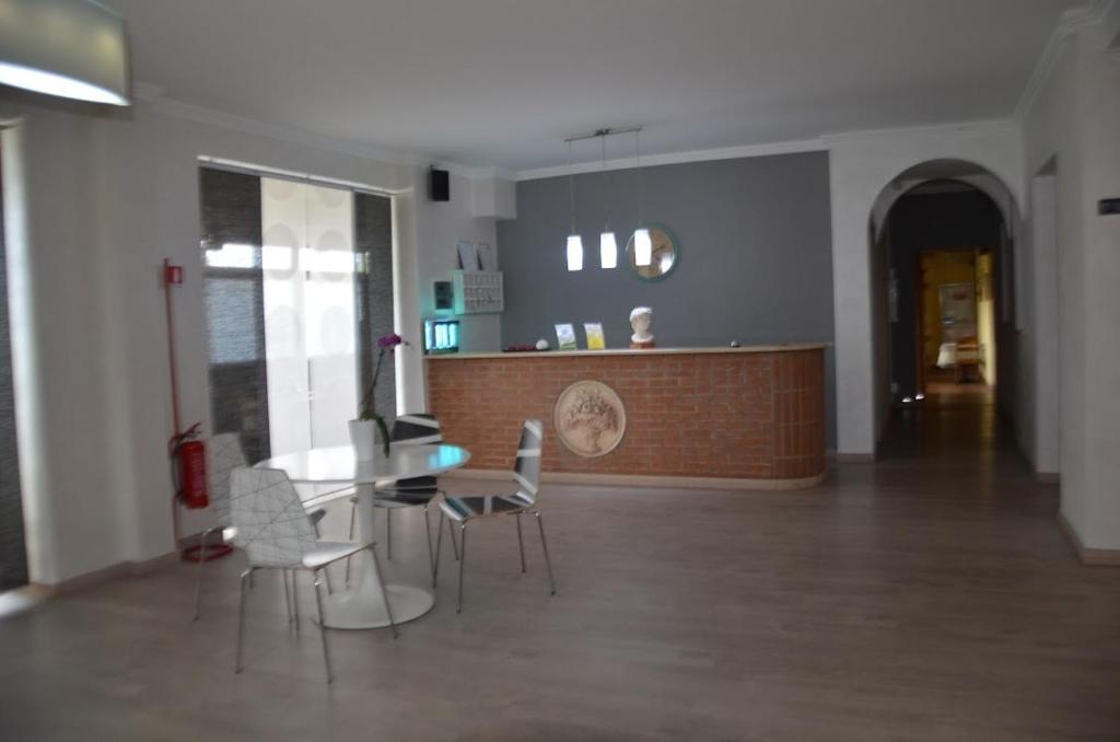 a room with a table and chairs and a counter at Hotel Bottaccio in Frascati