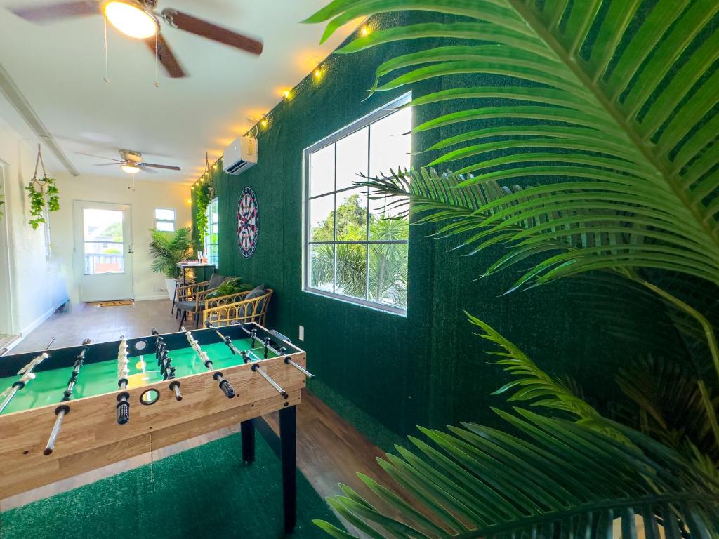 a ping pong table in a room with a green wall at Dream Home 10 Min To Beach W Shared Pool #21 in Clearwater
