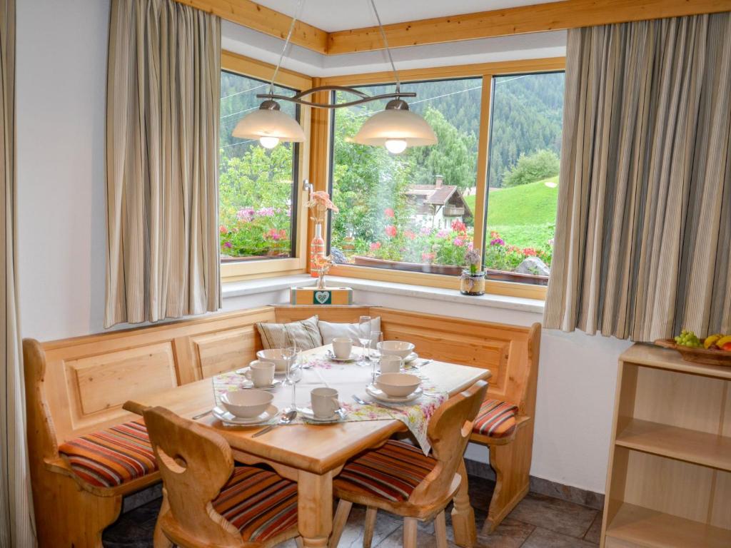 a dining room with a table and a window at Apartment Schöngraben by Interhome in Sankt Jakob