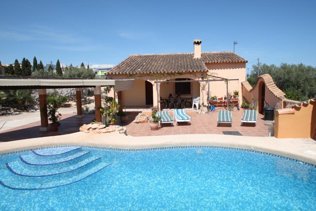 a swimming pool in front of a house at Pineda - modern, well-equipped villa with private pool in Costa Blanca in Benissa