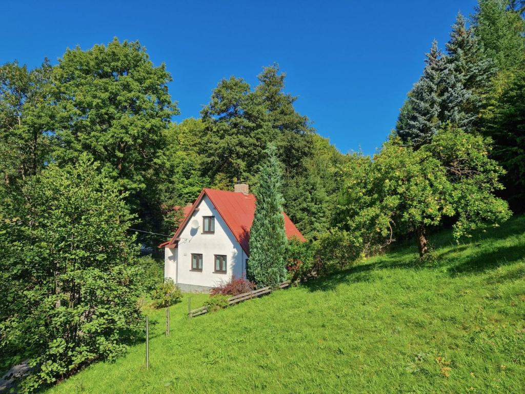 a small white house with a red roof on a hill at Holiday Home Jahor by Interhome in Splzov