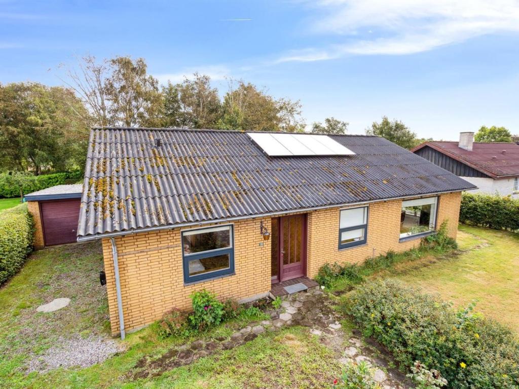 a house with solar panels on the roof at Holiday Home Magh - 9-8km from the sea in Western Jutland by Interhome in Tønder