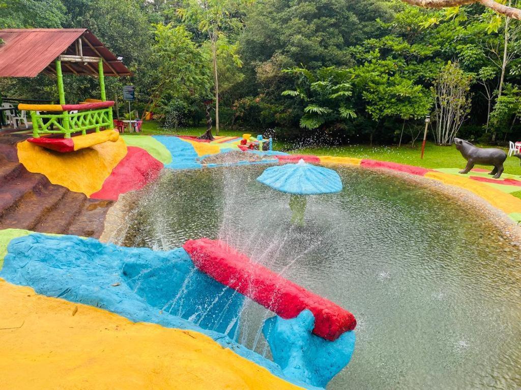 a water park with a water slide with an umbrella at Hotel Experiencia Viva in Mesa del Norte