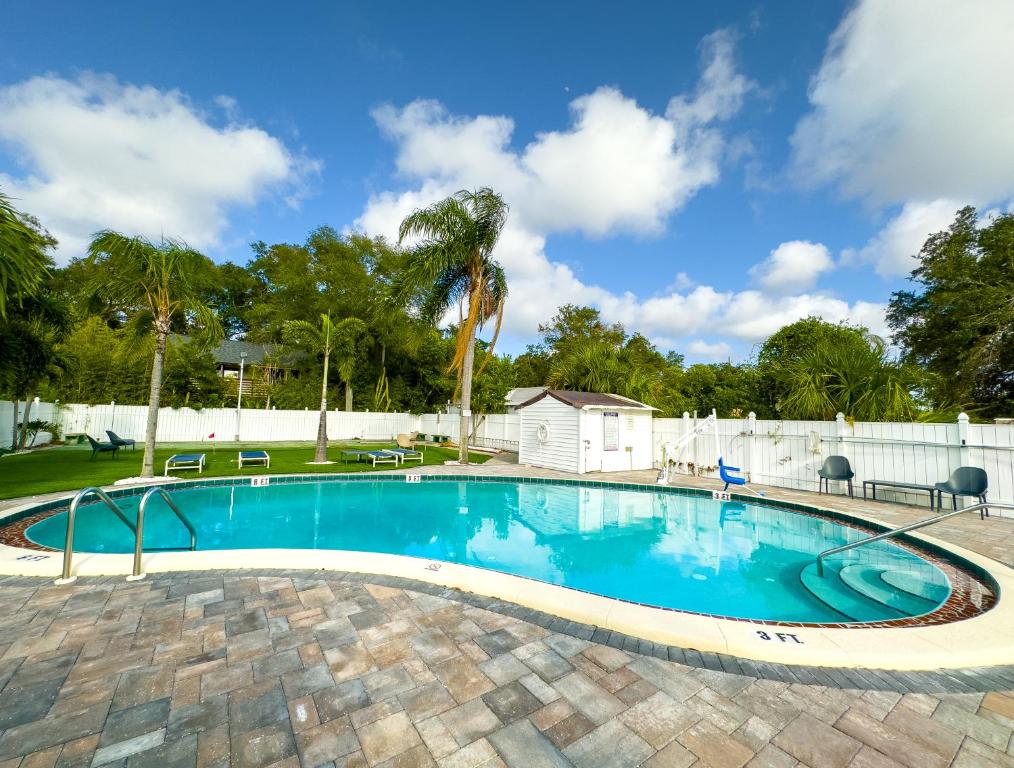 een zwembad in een tuin met een wit hek bij Dream Home 10 Min To Beach W Shared Pool #21 in Clearwater