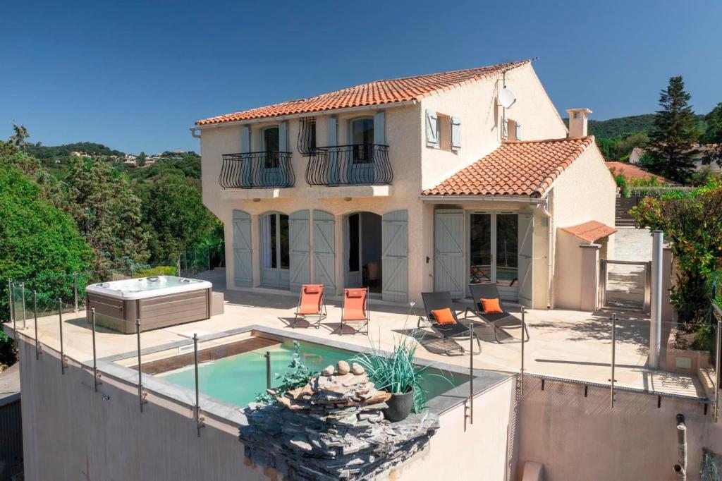 a villa with a swimming pool and a house at La Casa San Biaggio in Ajaccio