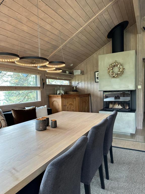 a dining room with a large wooden table and chairs at Special cottage in Sirdal in Tjørhom