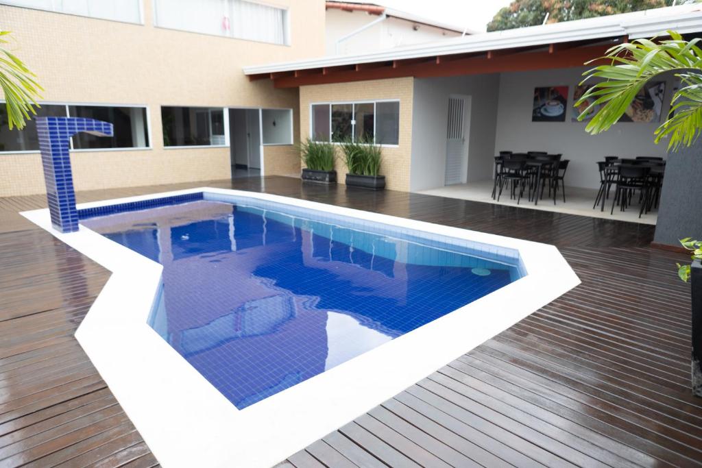a swimming pool in front of a house at Daho Hotel in Natal