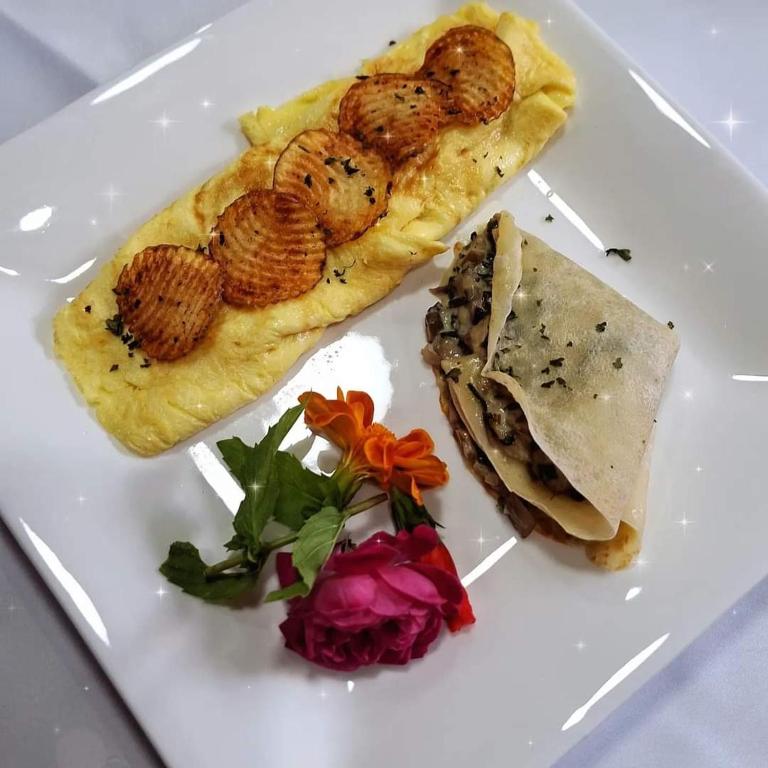 a white plate with some food on it at Myah's Hotel in Brighton Village