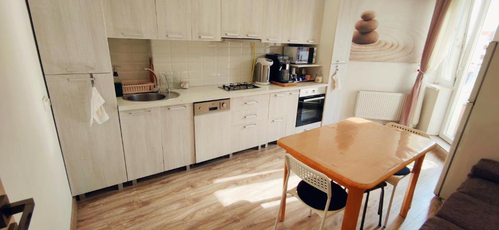 a small kitchen with a table and a refrigerator at Inessa center budget room in Chişinău