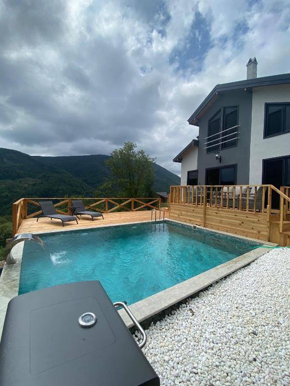 a swimming pool in front of a house at Sapanca Felix Suit Bungalow in Sakarya