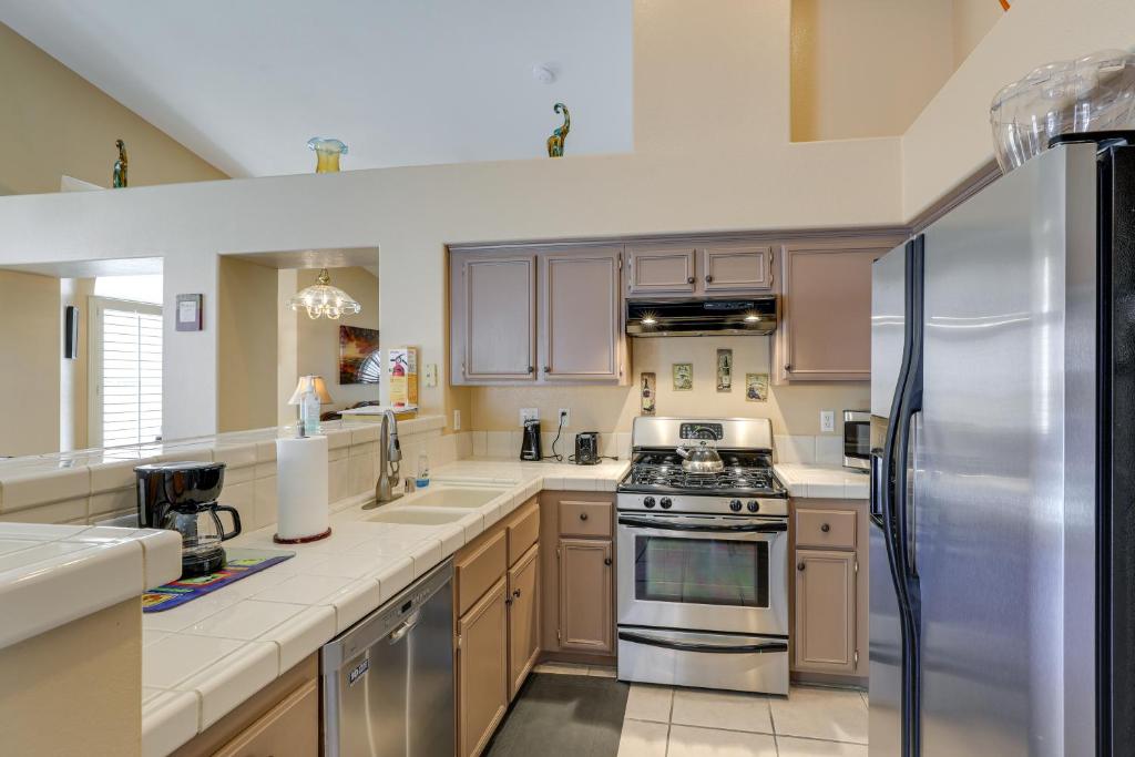 a kitchen with stainless steel appliances and wooden cabinets at North Las Vegas Home about 5 Mi to Fremont St! in Las Vegas