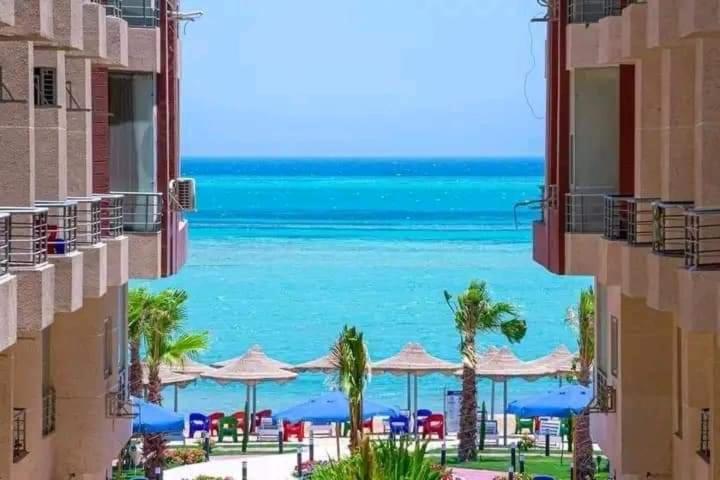 a view of the beach from between two buildings at Casablanca Beach for families and couples only in Hurghada