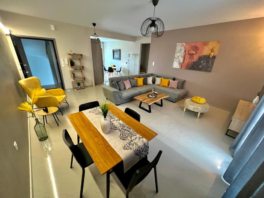a living room with a table and a couch at Aliki's House in Kalabaka