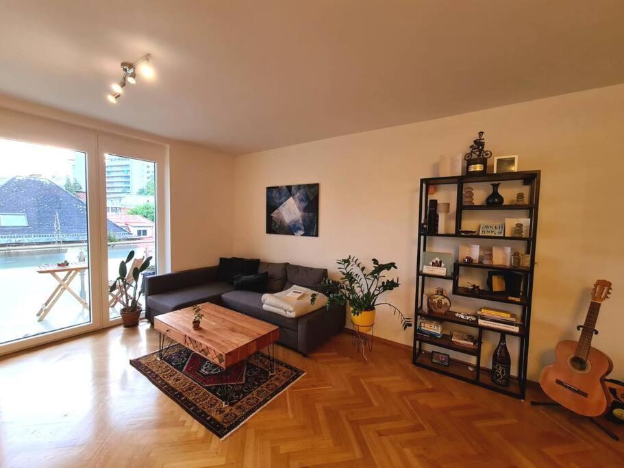 a living room with a couch and a table and a guitar at Michael's City Retreat in Graz