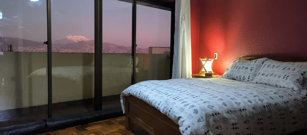 a bedroom with a bed and a window with a view at Caserita in La Paz