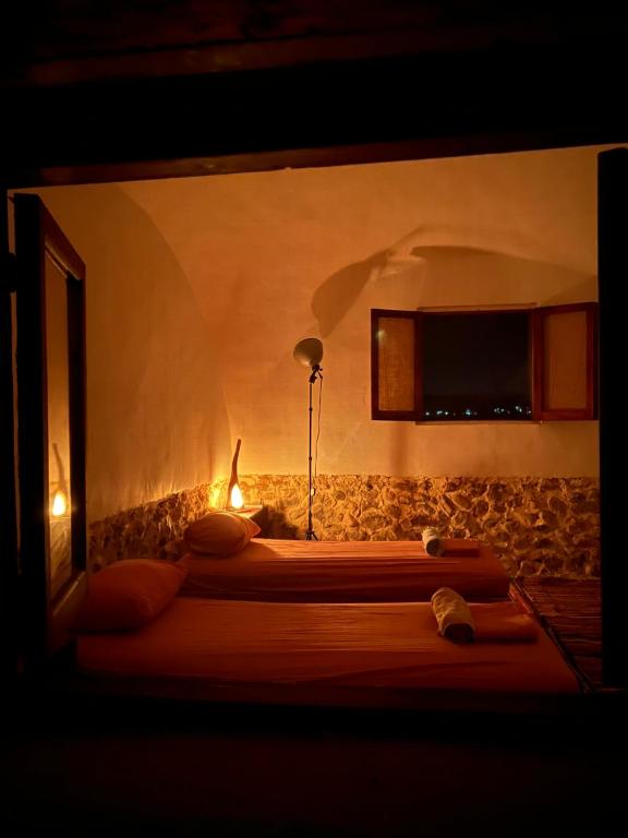 a bedroom with a bed with a tv on the wall at Farm’s guest room in Nuweiba