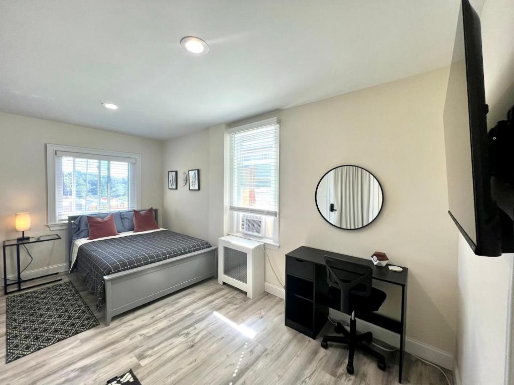 a bedroom with a bed and a desk and a mirror at 3-A Diamond in Yonkers, NY in Yonkers