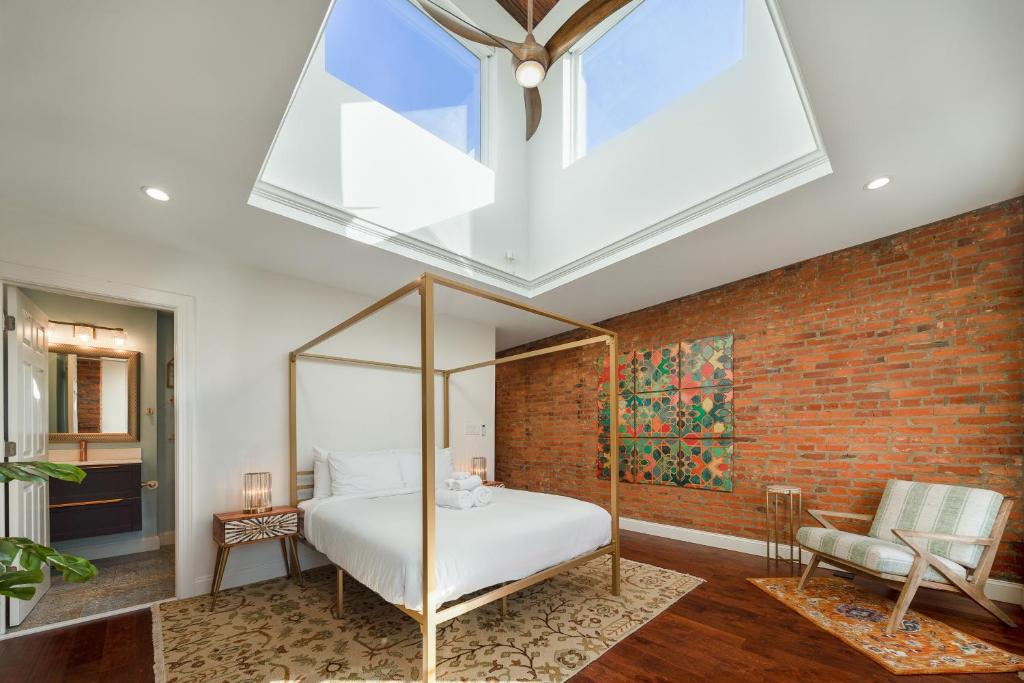 a bedroom with a bed and a brick wall at Chic Philadelphia Townhome in University City! in Philadelphia