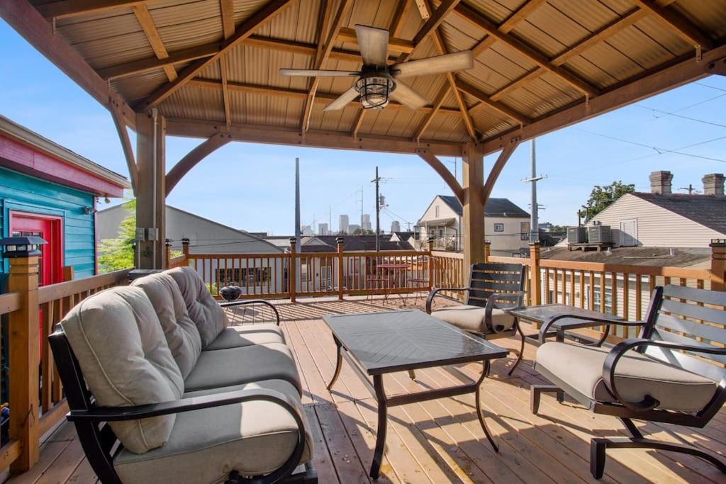a patio with chairs and a table on a deck at Spectacular Roof Top Deck - Luxury 3 bedroom in New Orleans