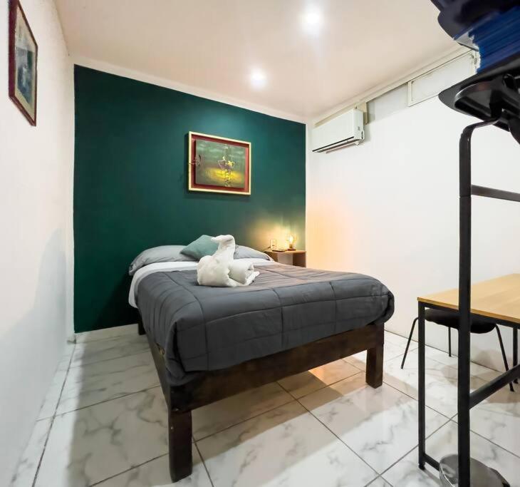 a bedroom with a bed with a stuffed animal on it at Cozy Apartment 10 min from downtown in San Luis Potosí