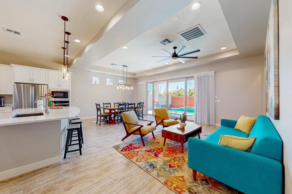 a living room with a blue couch and a kitchen at Desert Diamond in Gilbert