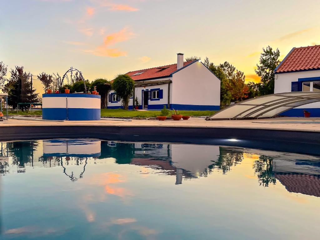 a pool of water in front of a house at Quinta do Cutato - Beatriz Guest House - Sotão in Santo Estêvão