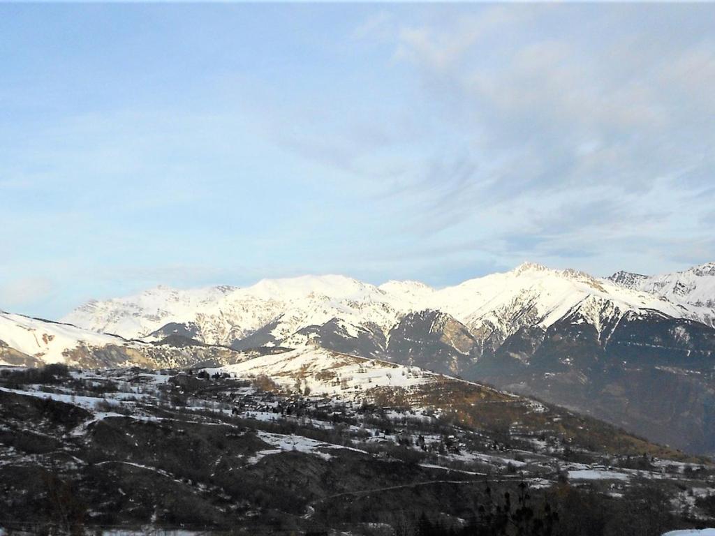 a mountain range with snow covered mountains in the background at Studio Le Corbier, 1 pièce, 5 personnes - FR-1-267-232 in Villarembert