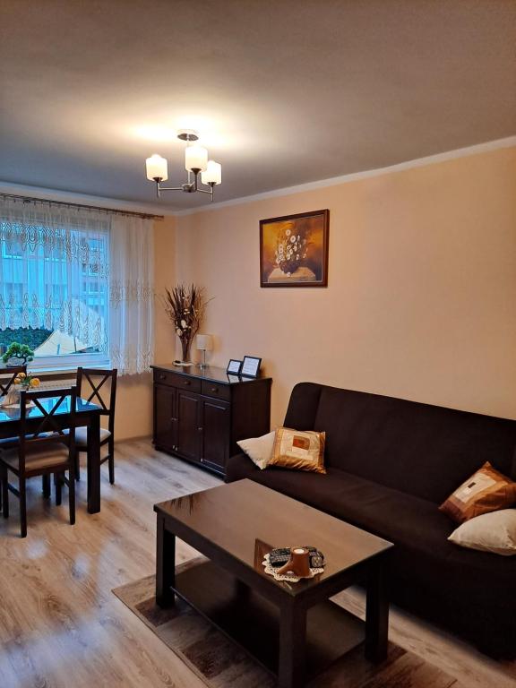 a living room with a couch and a table at MONICA in Jelenia Góra