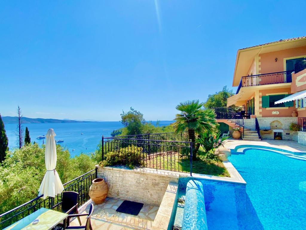 a villa with a swimming pool and a view of the ocean at Villa Eleni Kalami with private pool by DadoVillas in Kalami
