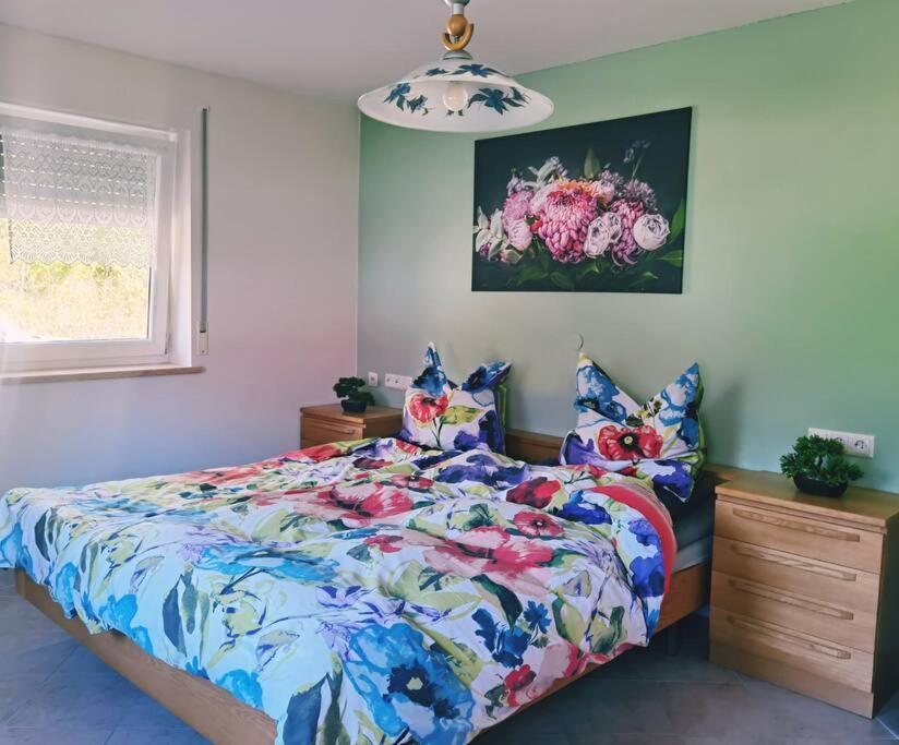 a bedroom with a bed with a colorful comforter at Ferienwohnung in Hornstein in Bingen