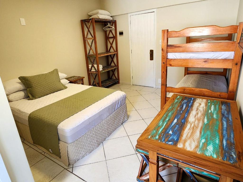 Postel nebo postele na pokoji v ubytování Flats Enseada Delphin
