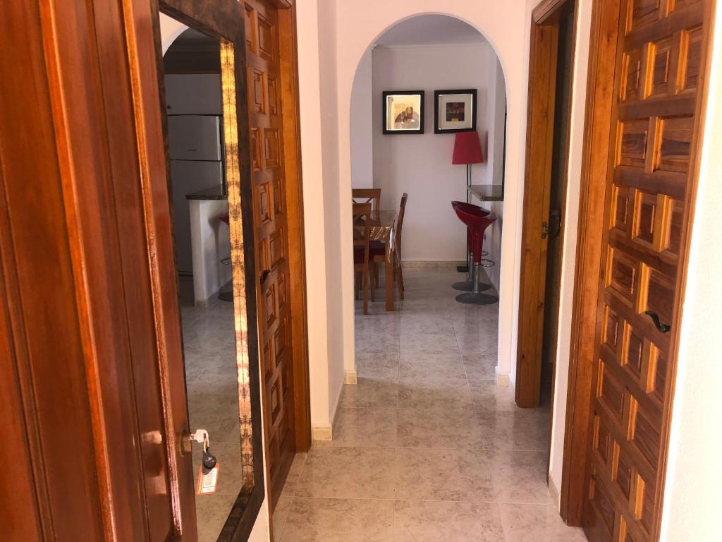 a hallway with an open door leading to a dining room at Paraíso in Cumbre del Sol