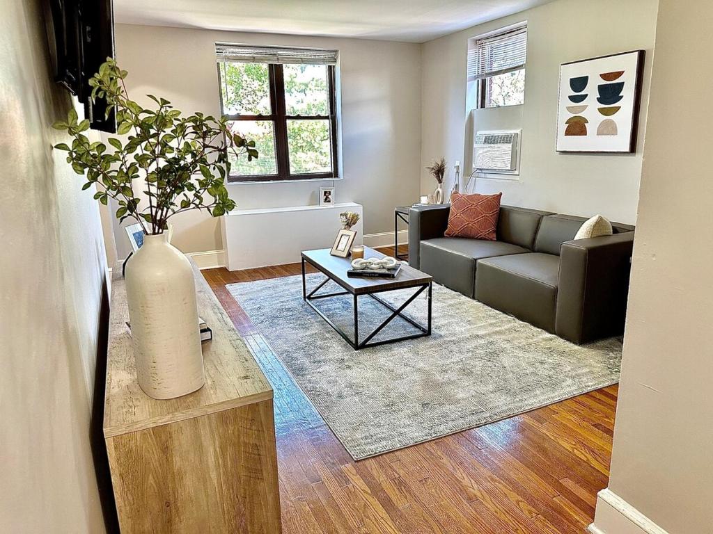 a living room with a couch and a vase on a table at Peaceful & Perfect Private 1-br I Lennox in Philadelphia