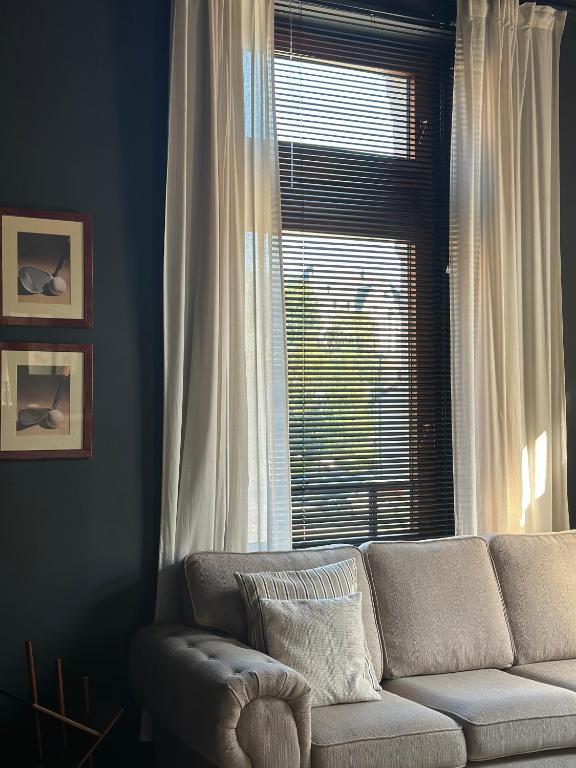 a living room with a couch and a window at Maison Comtale in Rochefort