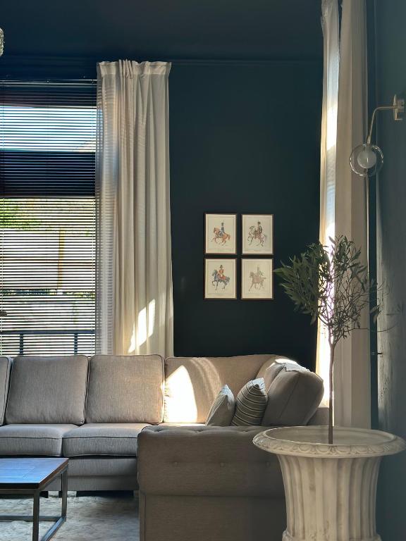 a living room with a couch and a table at Maison Comtale in Rochefort