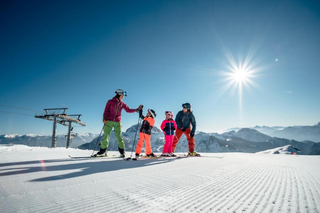 a group of people on skis on a ski slope at Panorama View Apartments Nassfeld in Hermagor
