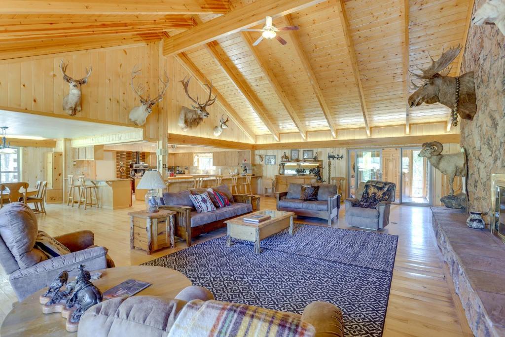 a large living room with couches and antlers on the wall at Spacious Dolores Vacation Rental with Decks and Views! in Dolores