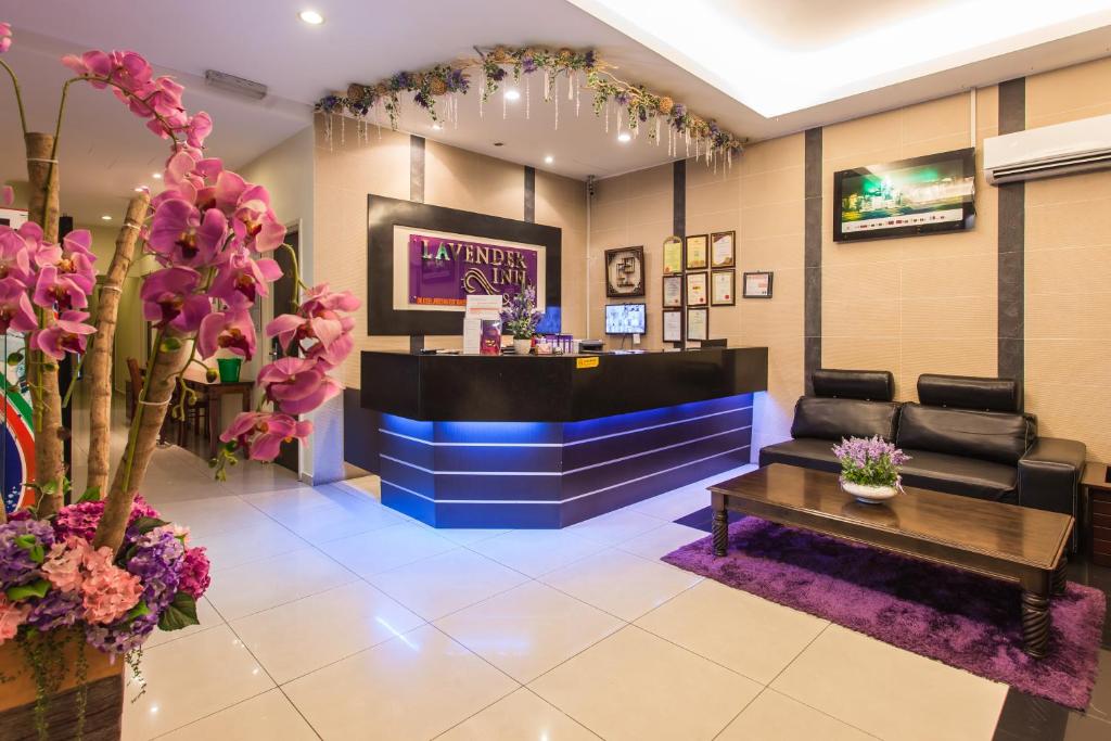 a salon with a waiting room with a table and flowers at Lavender Inn Permas Jaya in Johor Bahru