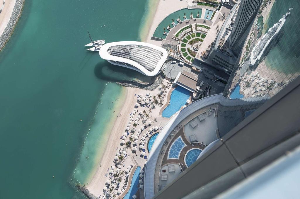 an aerial view of a beach and a stadium at Conrad Abu Dhabi Etihad Towers in Abu Dhabi