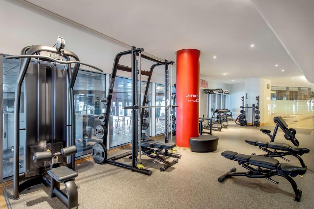 a gym with several treadmills and exercise bikes at Conrad Abu Dhabi Etihad Towers in Abu Dhabi